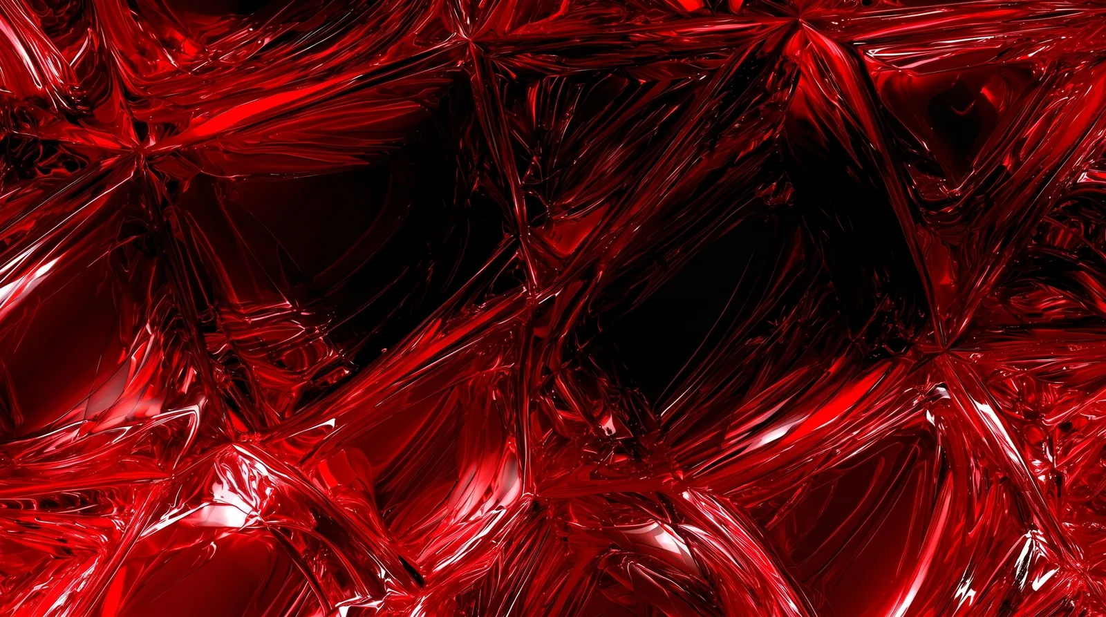 Faceted red glass catching light across a dark abstract surface